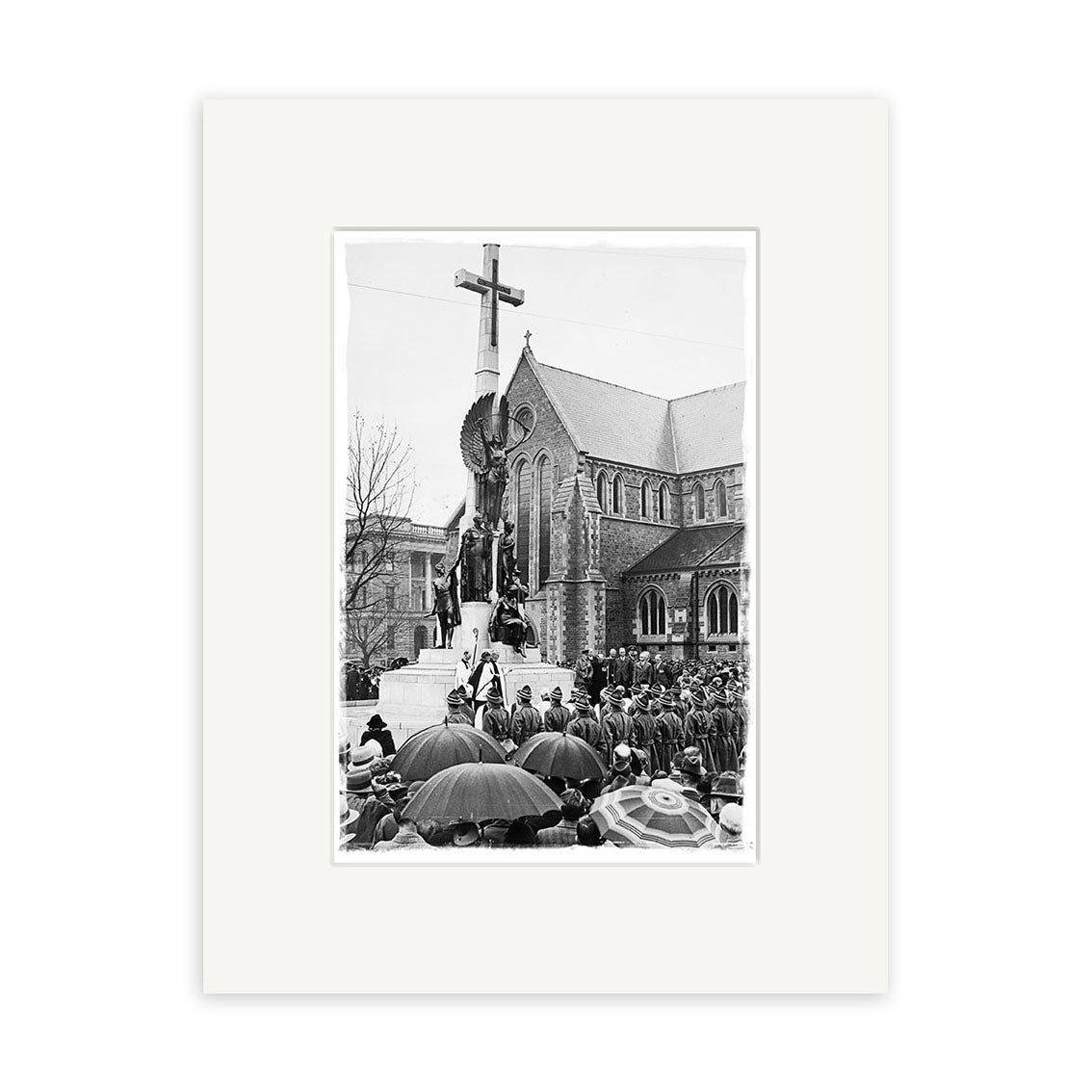 The War Memorial 1937 - HI208 features an archival black-and-white photo of a crowd with umbrellas outside a New Zealand stone church. A large cross stands in front, and several people are seen on a platform at its base.