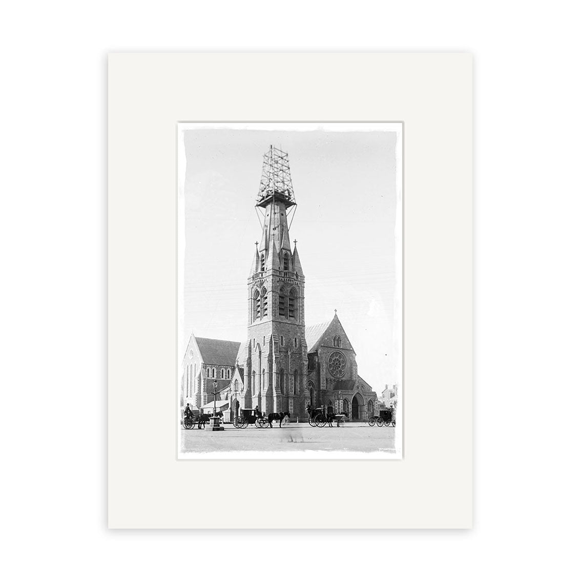 The “Cathedral Square 1903 - HI209” print shows a large Gothic-style church with a central tower under scaffolding in New Zealand, horse-drawn carriages in front, presented on archival-quality matte paper.