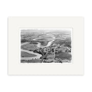 The Helensville 1951 - HI216 archival matte print features a black and white aerial image of a winding river through farmland and a small town, capturing the rural landscapes timeless charm.
