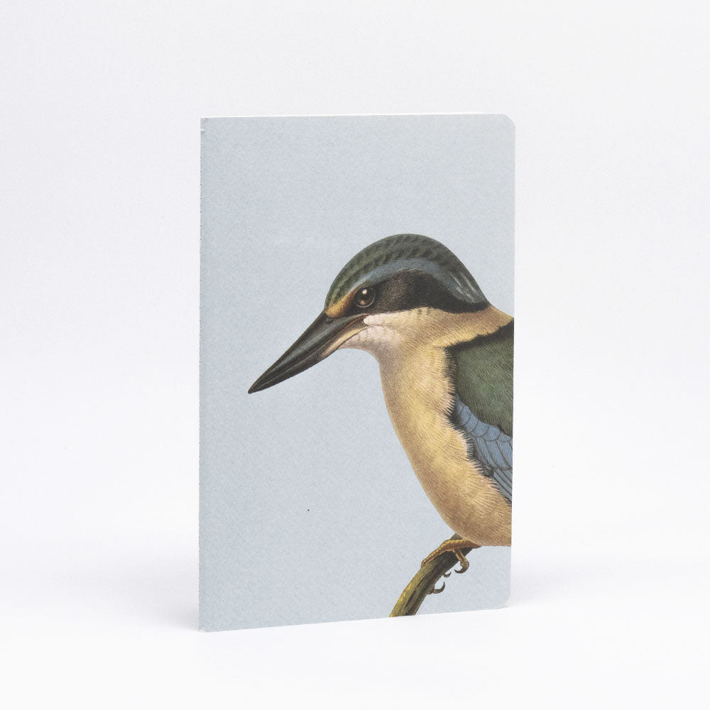 The Hushed Birds Notebook Set features hand-stitched notebooks with light gray covers, each adorned with a side-view illustration of a kingfisher bird perched on a branch against a plain white background.