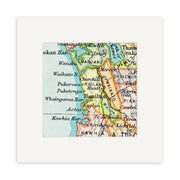 The Raglan Vintage Map Print is a close-up of a 19th-century lithograph showing New Zealands North Island, featuring place names like Hamilton, Raglan, Waikato, and Kawhia with colored boundaries and vintage typography.