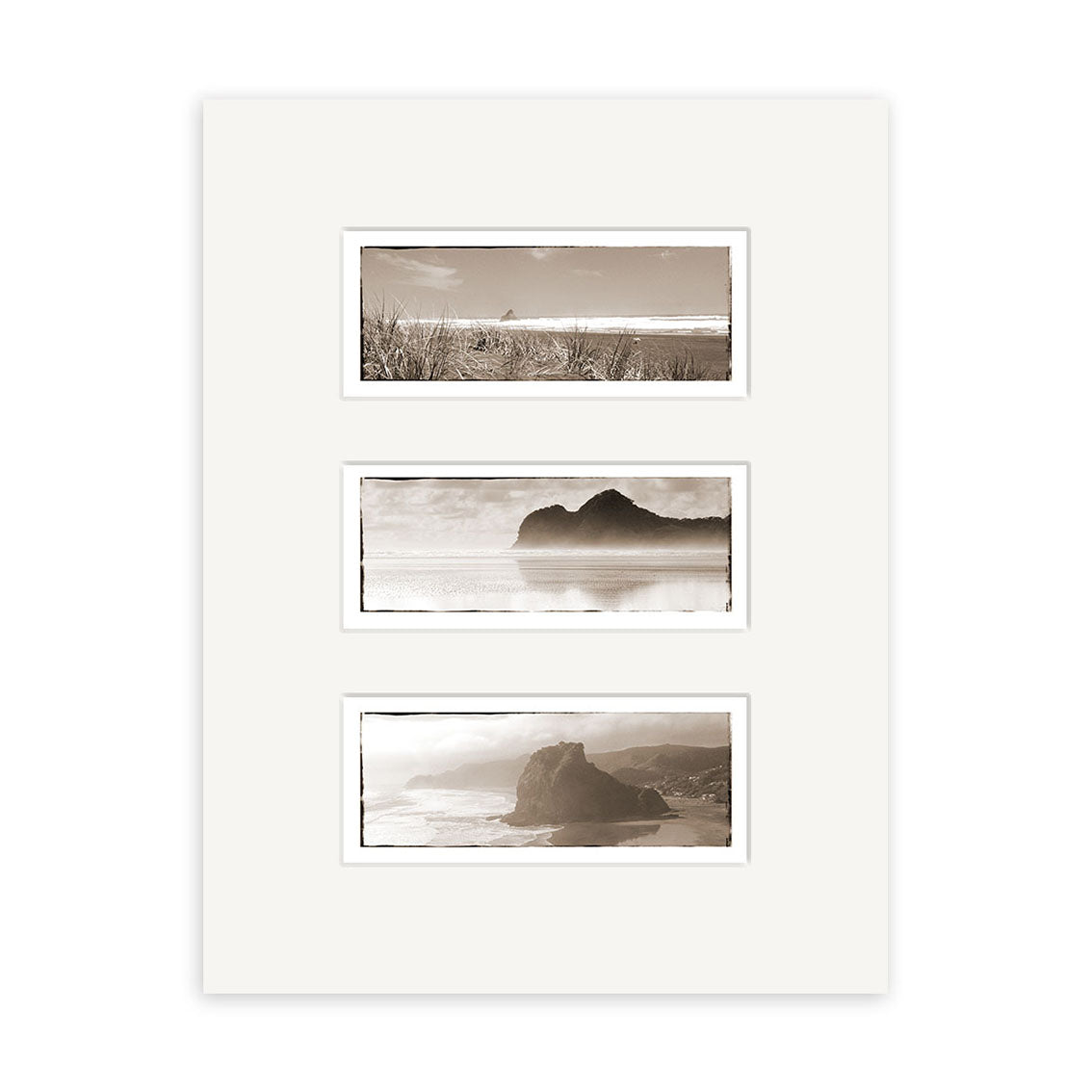 The West Coast Triptych - RP014 features three sepia-toned photos on archival paper in a white mat frame: grass and ocean at the top, a distant rocky formation in water in the center, and a coastal New Zealand cliff at the bottom.