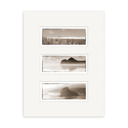 The West Coast Triptych - RP014 features three sepia-toned photos on archival paper in a white mat frame: grass and ocean at the top, a distant rocky formation in water in the center, and a coastal New Zealand cliff at the bottom.