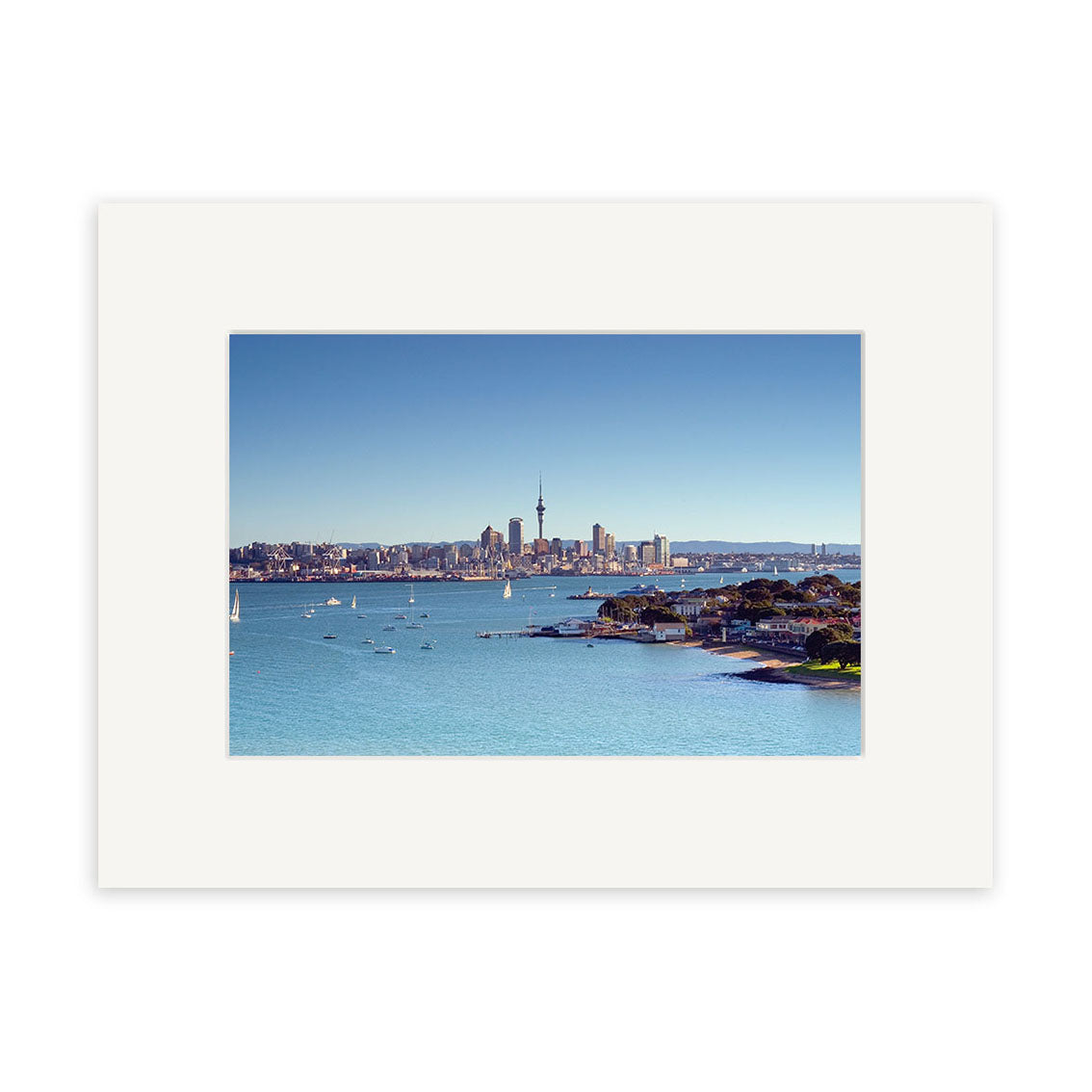 Devonport - RP006: Framed photograph by Reuben Price featuring a city skyline with a central tower and sailboats, printed on archival quality matte paper.