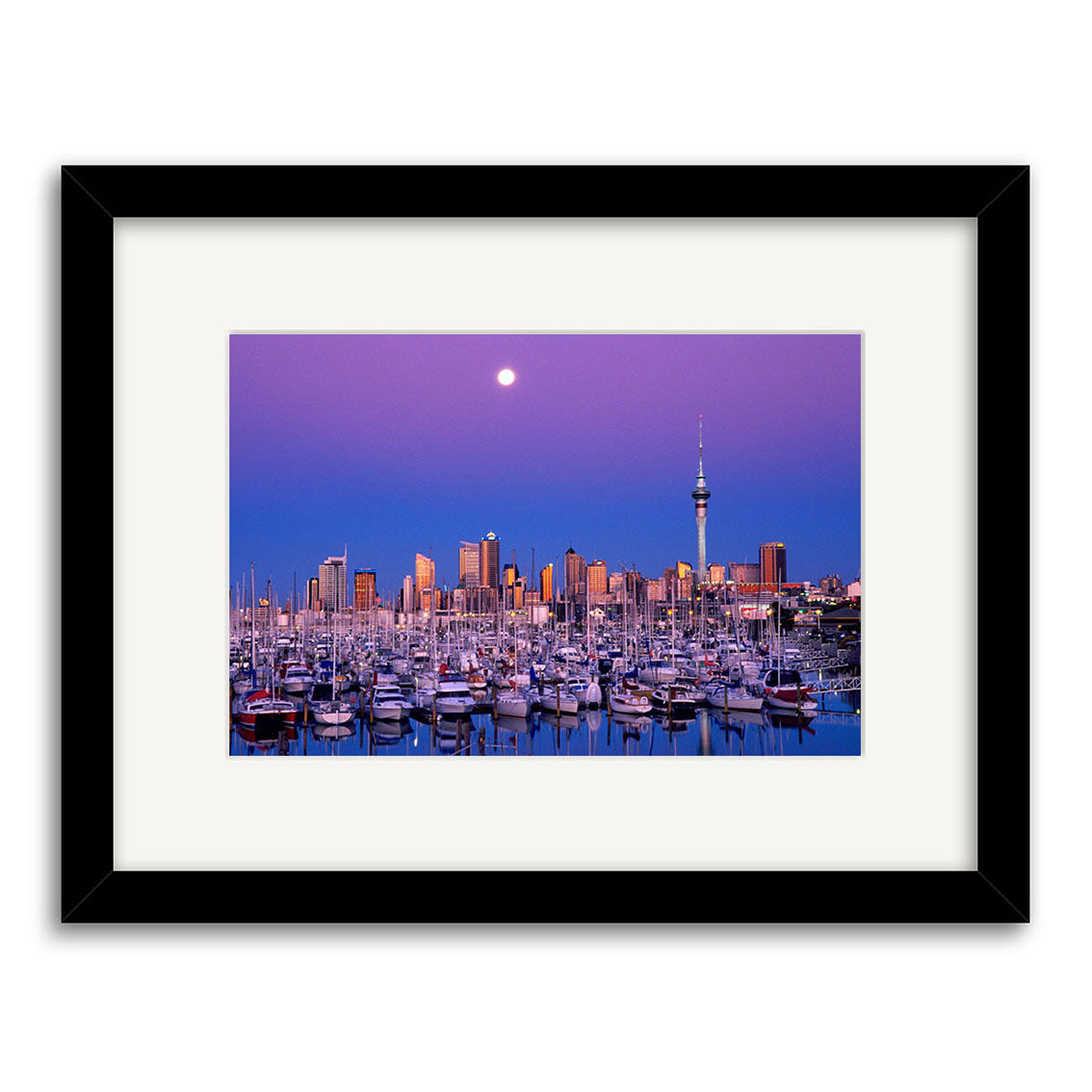 Twilight Boats - RP009 features a marina with many boats, city skyscrapers, a tall tower, and a full moon in a purple sky. This beautiful New Zealand scene is available as archival quality paper photographic prints.