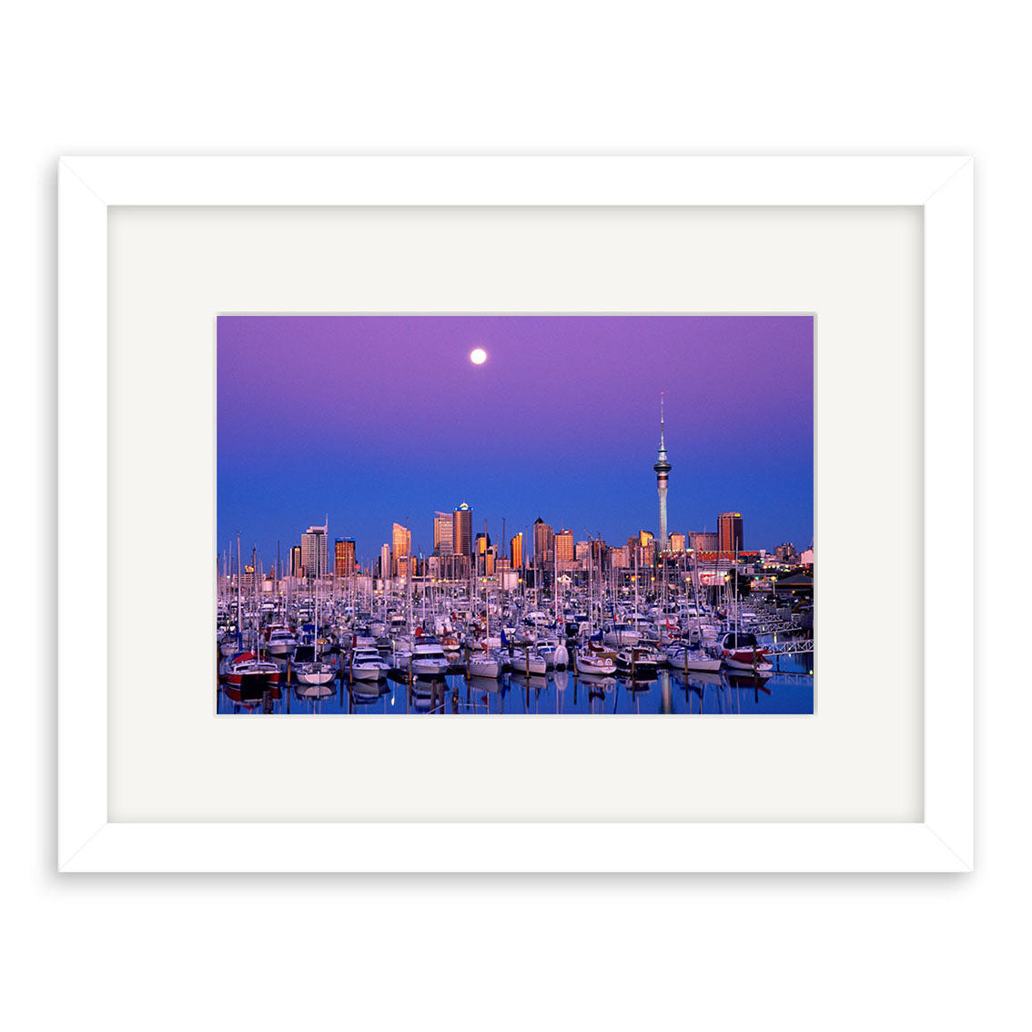 Twilight Boats - RP009: Framed photo of a New Zealand marina at dusk, city skyline and tower in the background under a full moon. Centered on archival quality paper with white mat and frame.