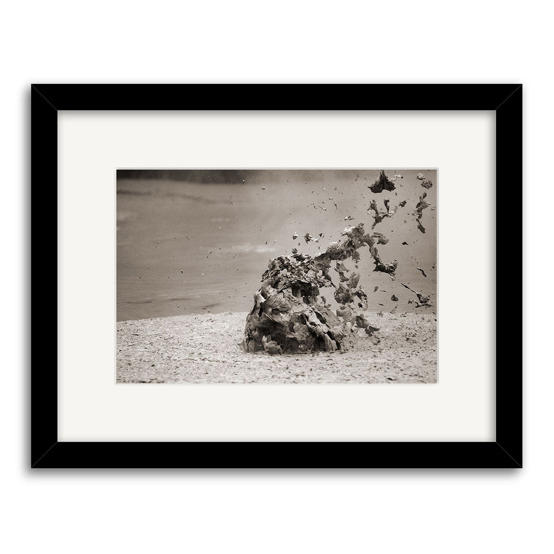 Mud Pool, Rotorua - RP036: A framed black and white photo of a mud eruption in New Zealand, featuring mud splashing from a central mound. Printed on archival quality matte paper for lasting photographic prints.