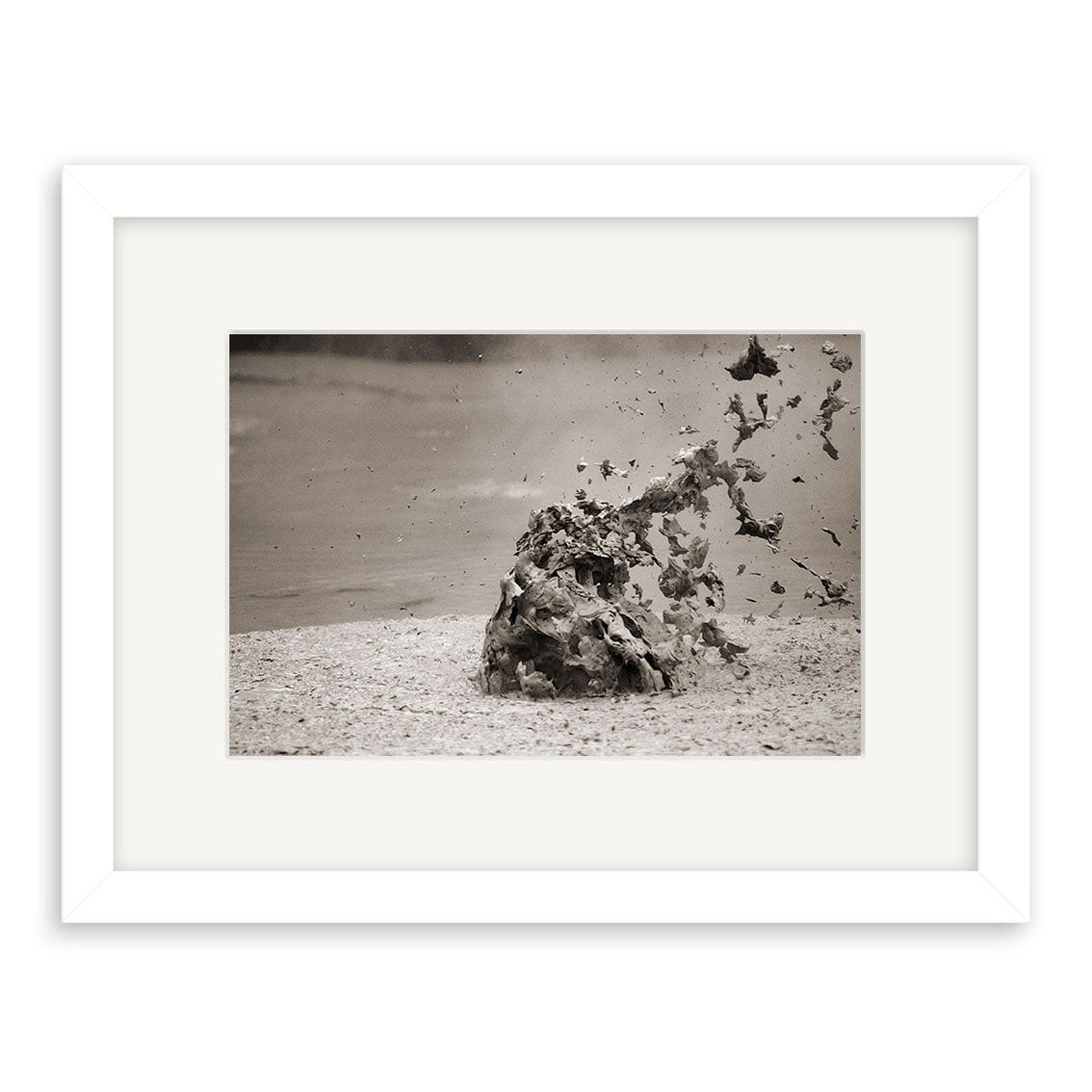 Mud Pool, Rotorua - RP036 is a black-and-white photo of mud and droplets erupting from a bubbling pool in New Zealand, presented in a white mat and frame—ideal as an archival quality matte paper photographic print.