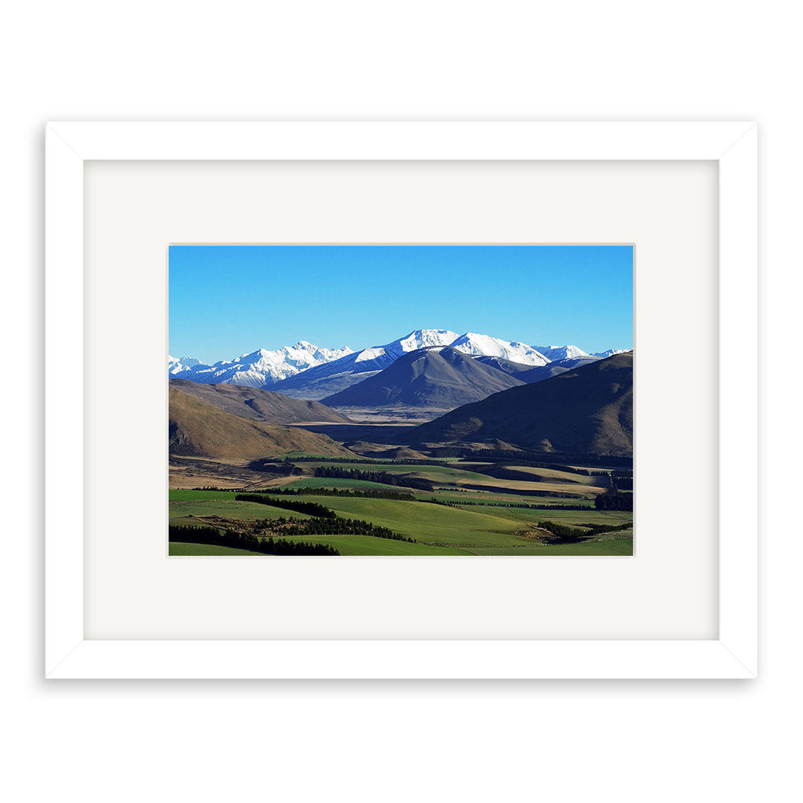 Inverary - RP046: A framed landscape photo of snow-capped mountains, rolling hills, and green fields beneath a blue sky, printed on archival-quality matte paper for lasting beauty.