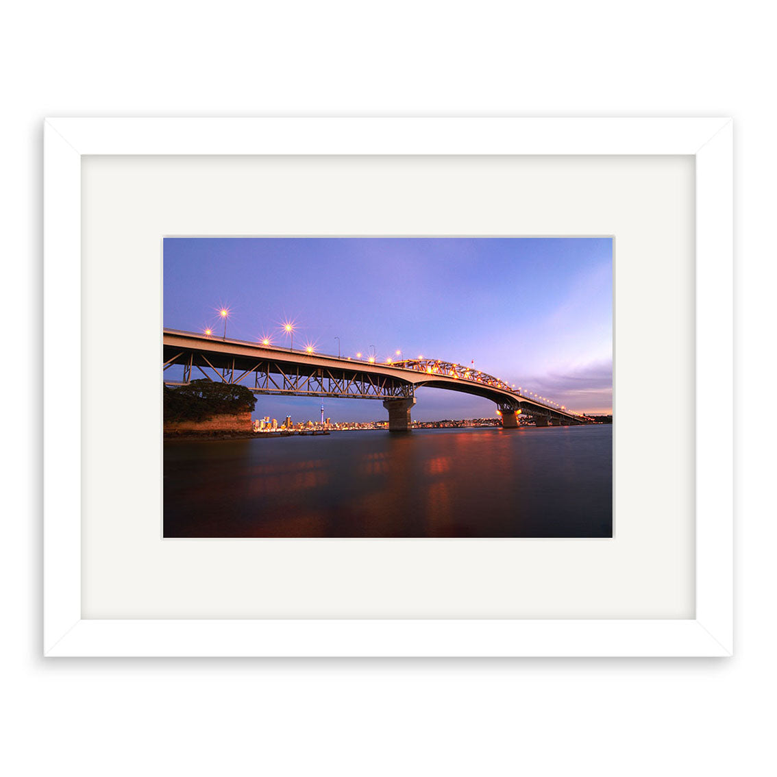 Auckland Harbour Bridge - RP090: A framed photographic print of the illuminated Auckland Harbour Bridge at dusk, city lights shining under a twilight sky, beautifully rendered on archival quality matte paper.