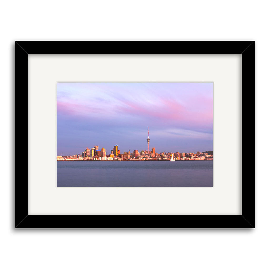 Framed archival quality photographic print, Auckland Twilight Skyline - RP092, features New Zealands waterfront with city buildings, a tall observation tower, and sunset skies of pink and purple clouds.