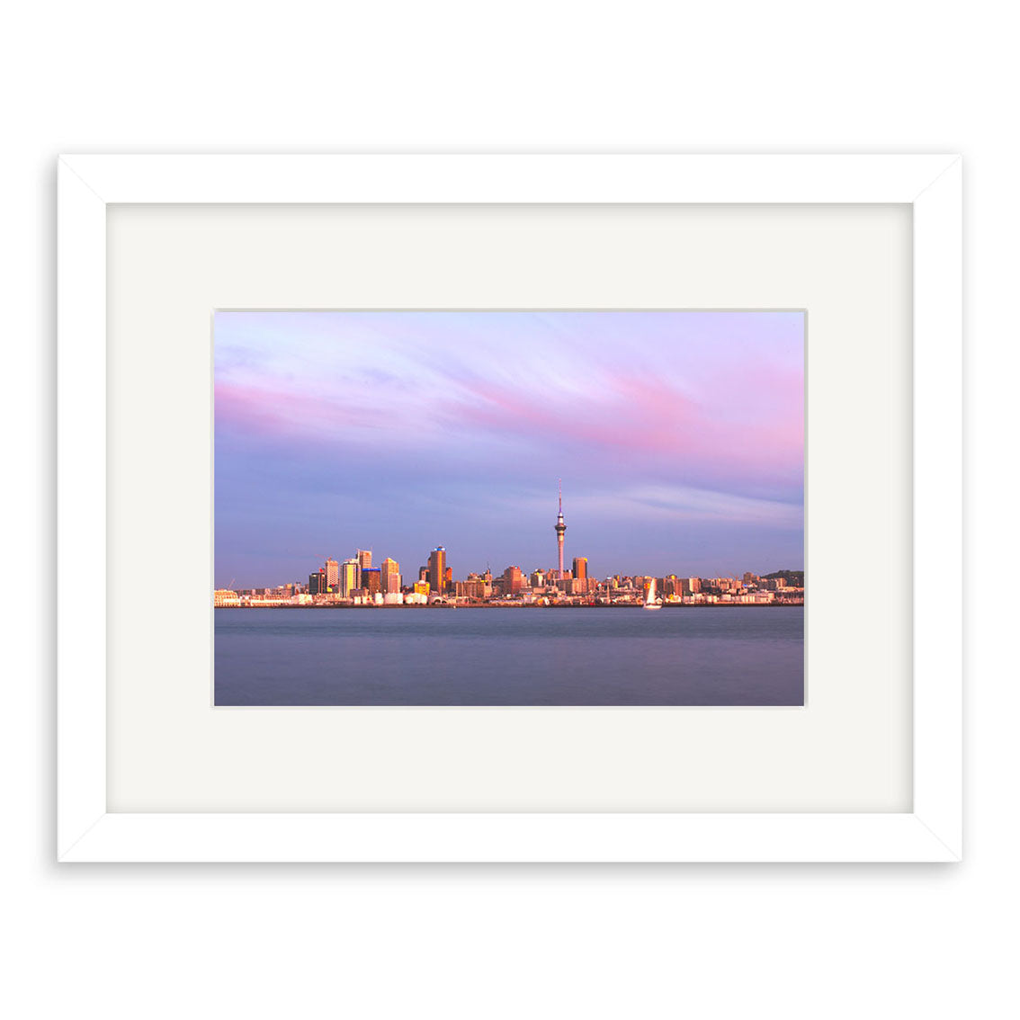 The Auckland Twilight Skyline - RP092 framed print showcases Auckland’s skyline at sunset, with tall buildings and a prominent tower beneath pink and purple clouds above calm water, printed on archival-quality paper.