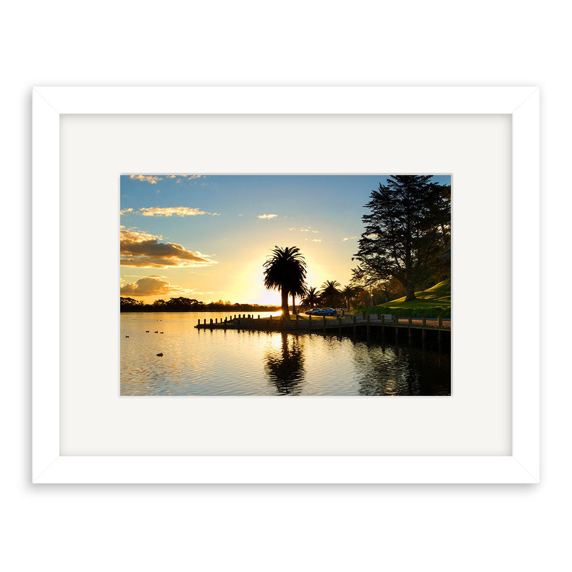 Enjoy Hamilton Lake - RP097: a framed photographic print of a sunset lakeside scene in New Zealand, with palm trees, a wooden pier, and reflections on calm water. Printed on archival quality matte paper for lasting beauty.