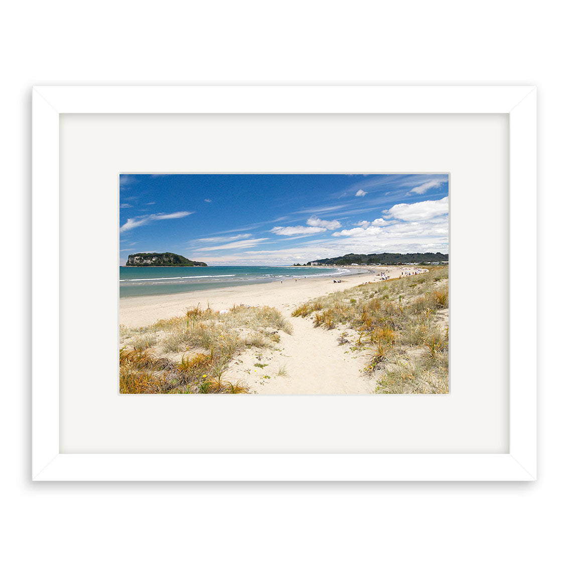 Whangamata - RP128 is a framed photographic print on archival matte paper, featuring New Zealands stunning coastline with sandy beach, grassy dunes, blue ocean, distant landforms, and people along the shoreline.