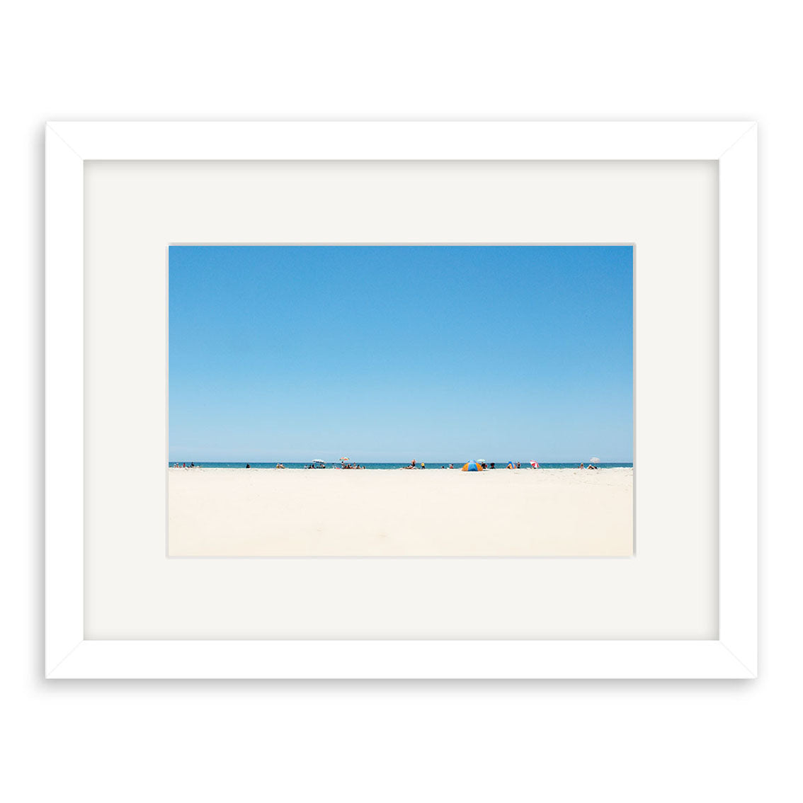 Pakiri Beach - RP142 is a framed photographic print by Reuben Price featuring pale sand, a blue ocean, clear sky, and small figures with colorful tents near the shoreline of a New Zealand beach.