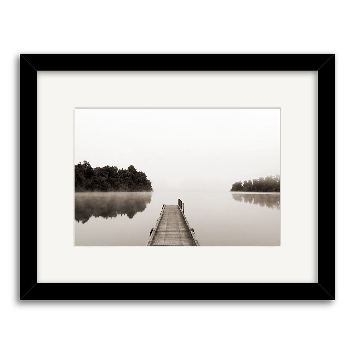 Lake Mapourika - RP156 is a framed black-and-white photo by Reuben Price featuring a wooden dock stretching into a tranquil lake, flanked by trees and misty skies—one of his striking New Zealand photographic prints.