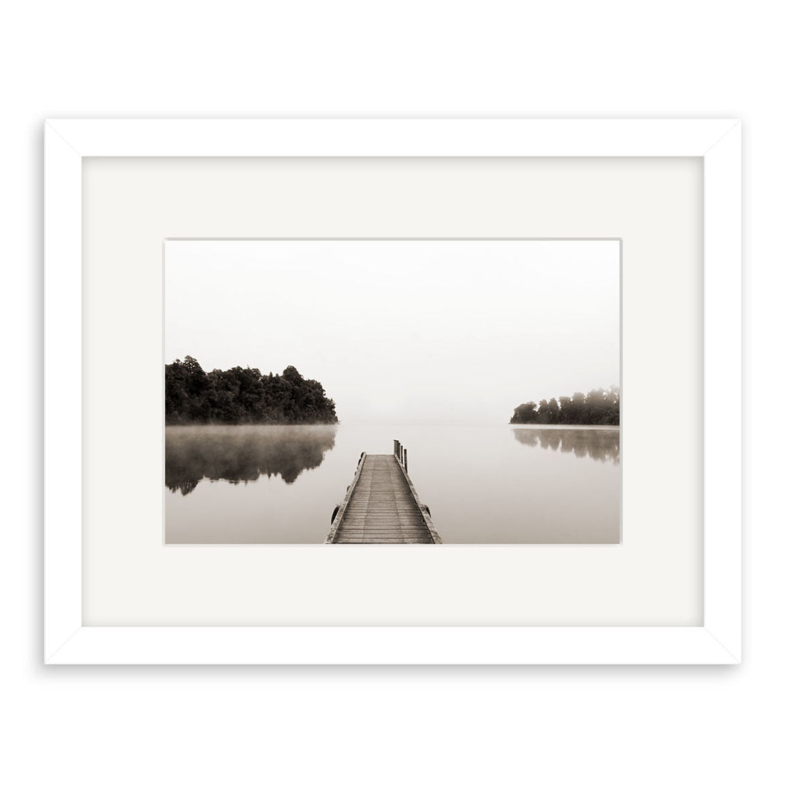 The Lake Mapourika - RP156 is a framed Reuben Price black and white archival print featuring a wooden dock extending into a serene, misty lake bordered by trees, elegantly presented in a white mat and frame.
