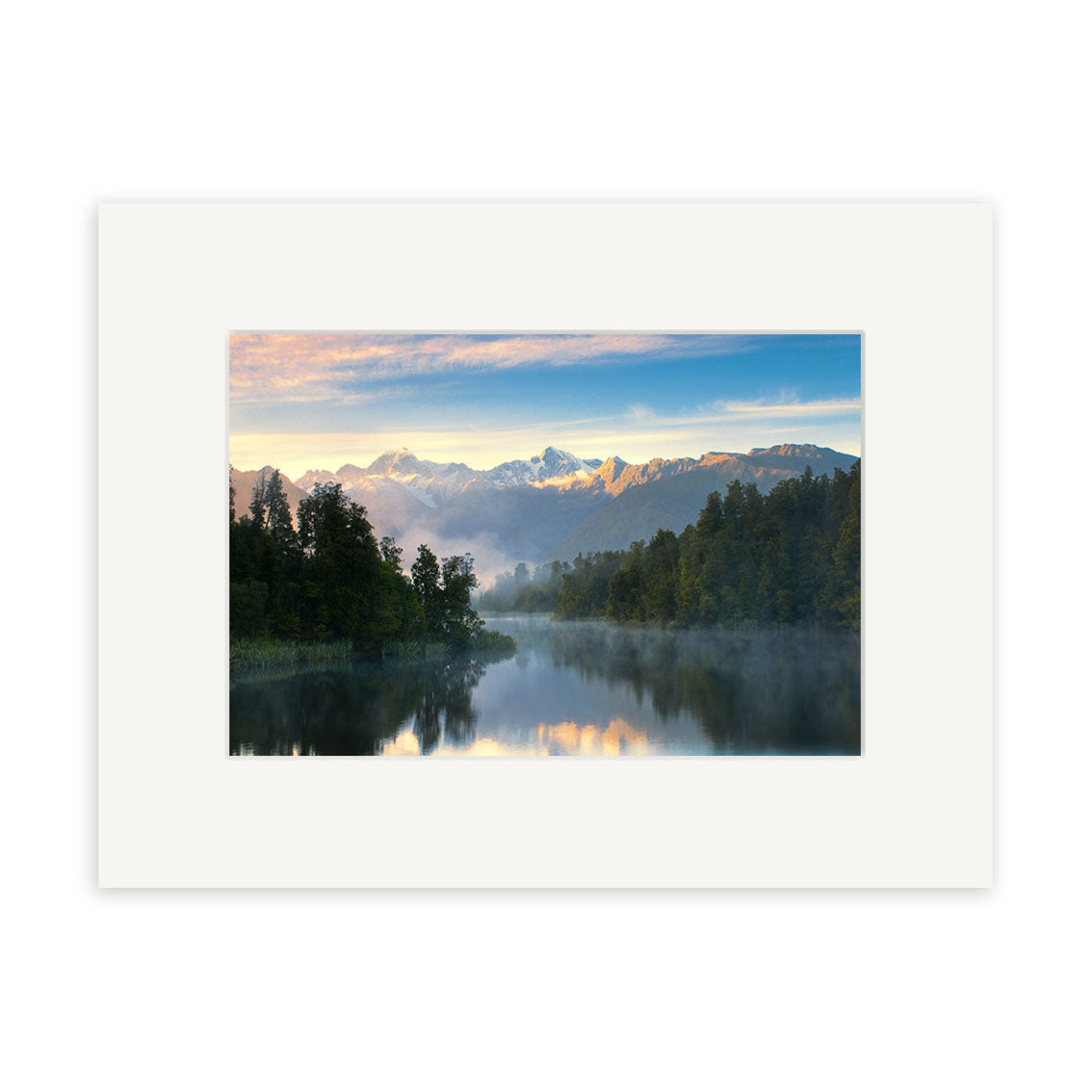 A landscape photo titled Lake Matheson - RP157 by Reuben Price shows a calm New Zealand lake with mist, trees, snow-capped mountains, and a cloudy blue sky, displayed in a white mat frame.