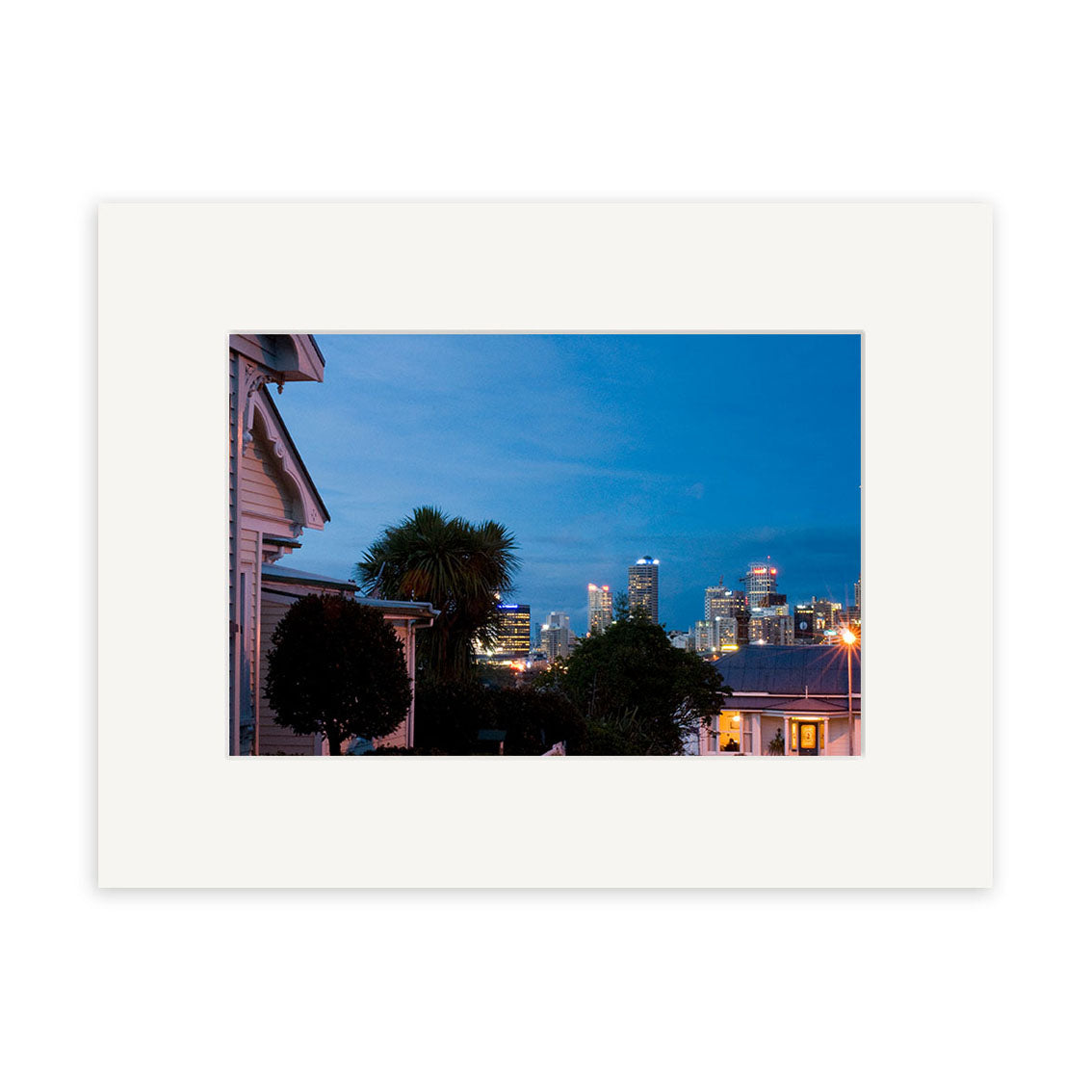 Ponsonby - RP200 captures a dusk cityscape in New Zealand, with houses and trees in front of glowing skyscrapers beneath a blue sky—ideal for stunning photographic prints on archival quality matte paper.