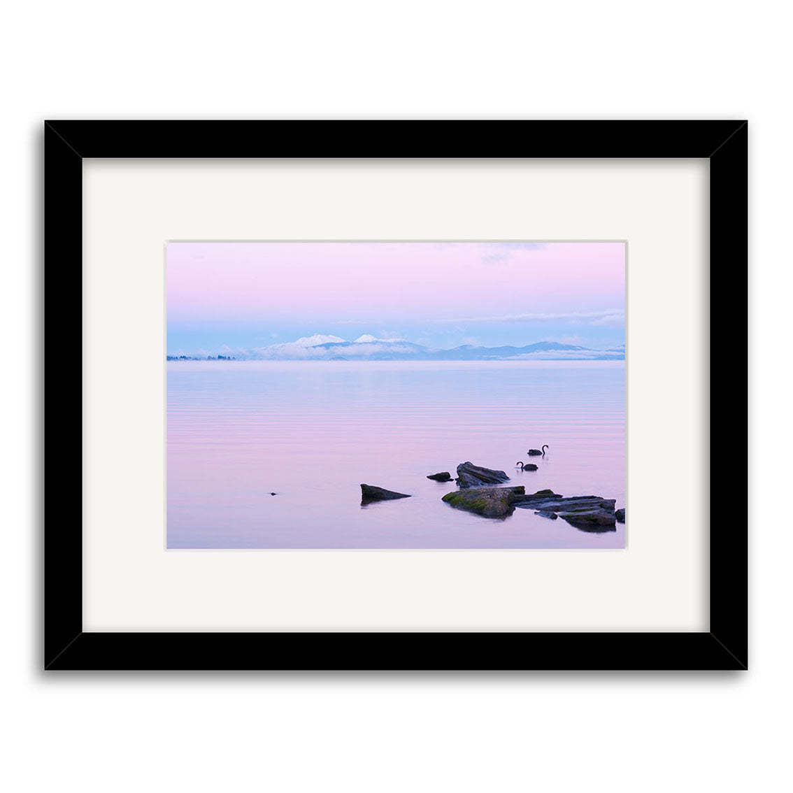Lake Taupo - RP237: A stunning framed photo of a calm lake at sunset, with rocks, two birds, and snow-capped mountains under a pastel pink and blue sky—archival quality matte photographic print.