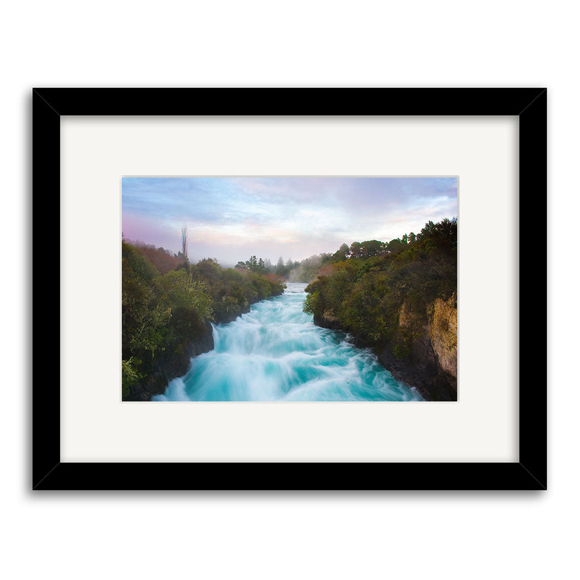 A framed photograph titled Huka Falls - RP238 shows a wide turquoise river in New Zealand, rushing between lush green banks under a partly cloudy sky. Mist rises from the water. Printed on archival quality paper for lasting beauty.