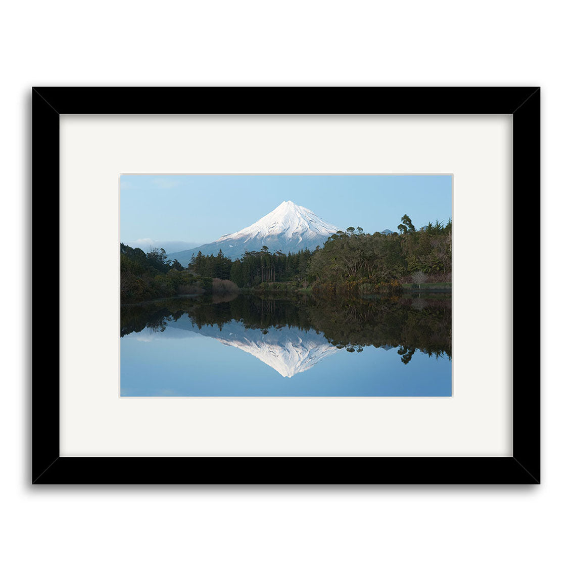 The framed archival print Lake Mangamahoe - RP239 features a snow-capped New Zealand mountain mirrored in a calm lake, with trees and greenery in the foreground under a clear sky. It comes with a black frame and white mat.