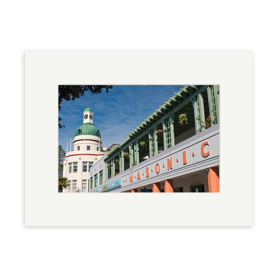 A photo of the Napier - RP255 building with a green dome and large orange MASONIC sign beneath a blue New Zealand sky. Features green railings and balcony plants. Available as archival quality matte paper print.