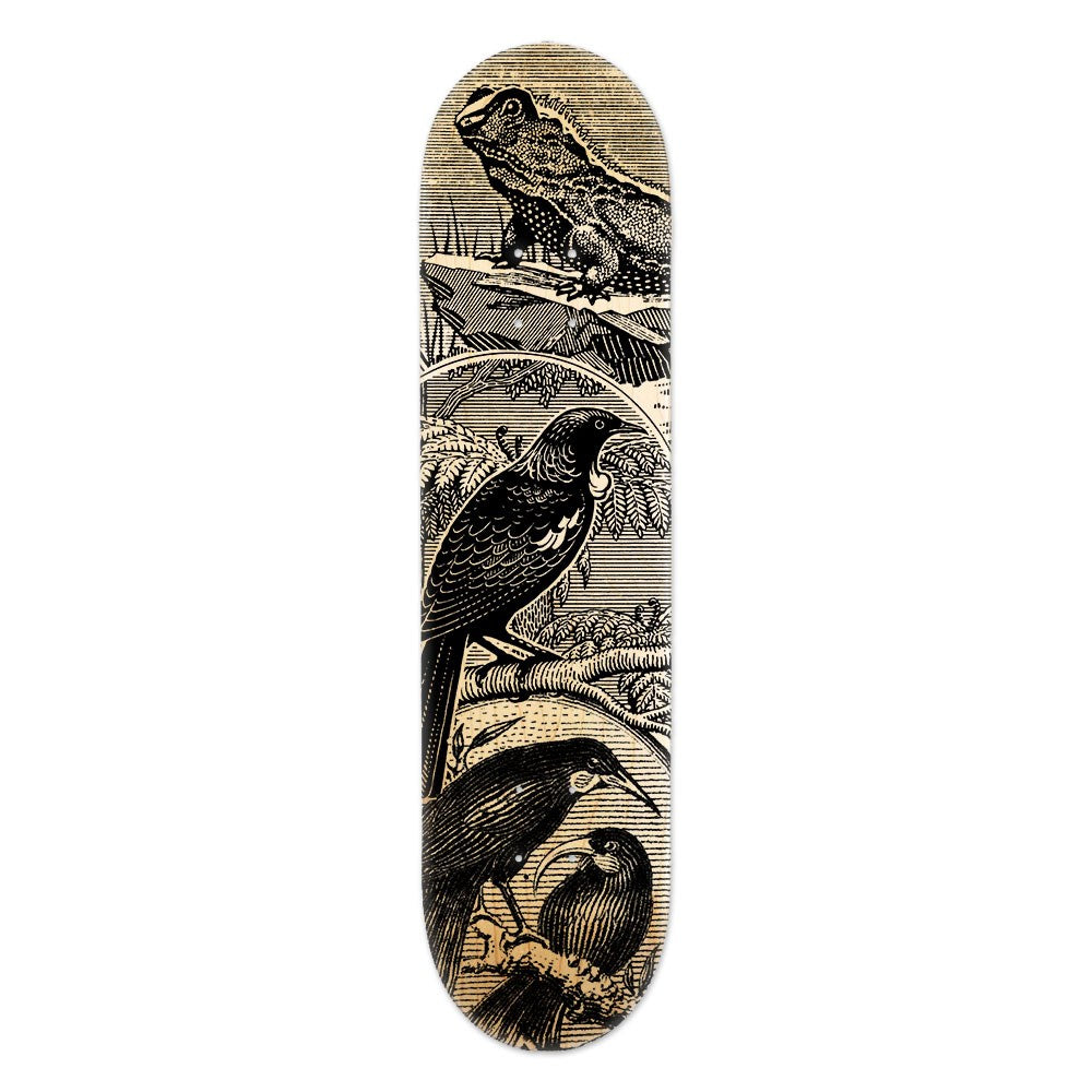 The Tuatara Stamp Skateboard Deck is a Canadian maple deck featuring vintage-style illustrations of a frog and three birds amid foliage, blending natural elements into a unique piece of contemporary art.
