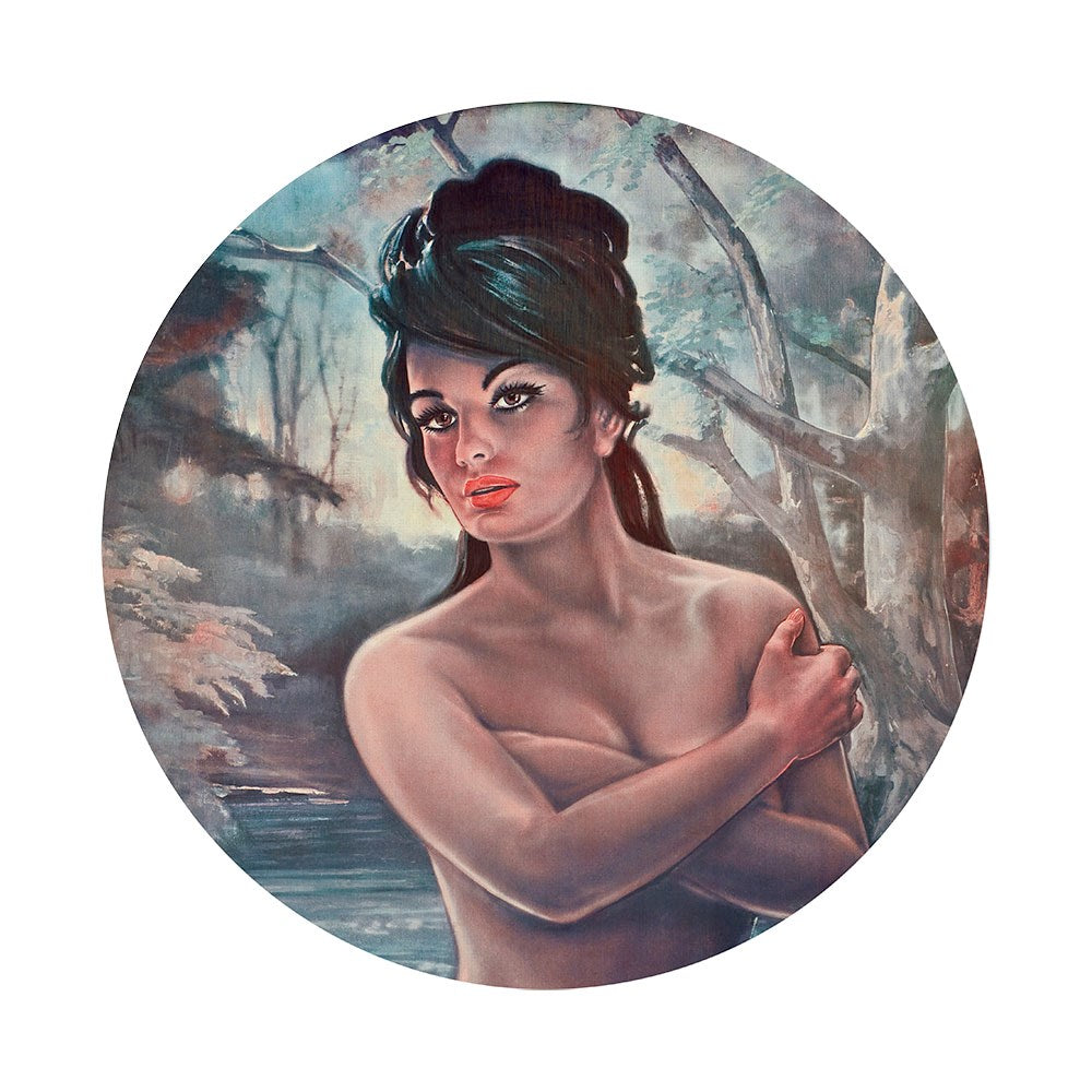 The Nymph Art Spot is a circular vintage-style J.H. Lynch print featuring a topless dark-haired woman crossing her arms before a forest backdrop—perfect retro-chic wall art for mid-century decor lovers.
