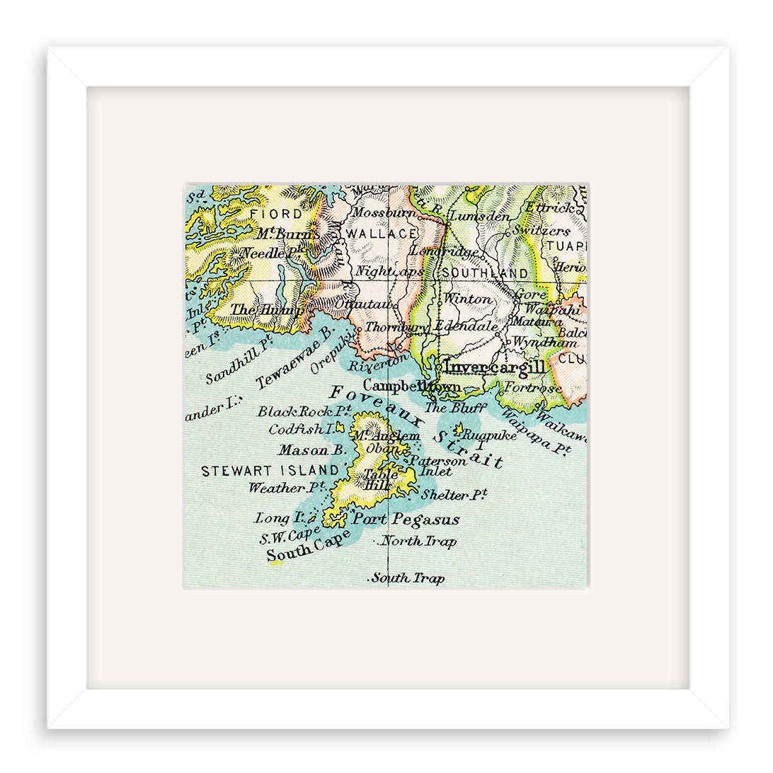 The Stewart Island Vintage Map Print features a pastel-colored giclee map of southern New Zealand—including Southland, Fiordland, Invercargill, and Stewart Island—labeled with place names and set in a white frame.