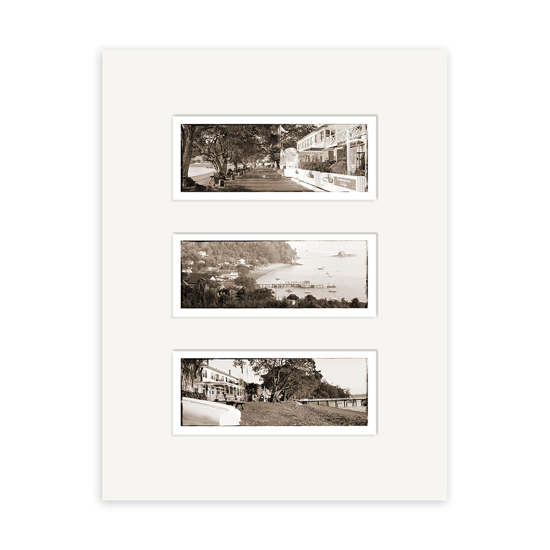 The Russell Triptych - RP028 features three black-and-white outdoor photos on a white mat board, arranged vertically to depict vintage New Zealand scenes with buildings, trees, water, and boats in archival quality.