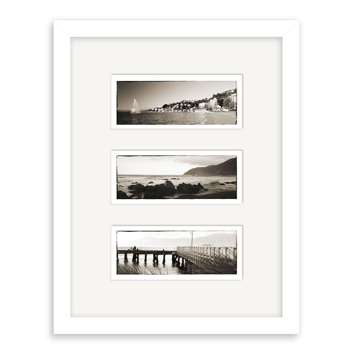 The Wellington Triptych - RP105 features three black-and-white New Zealand coastal prints by Reuben Price, arranged vertically on a white mat and presented in a white frame.