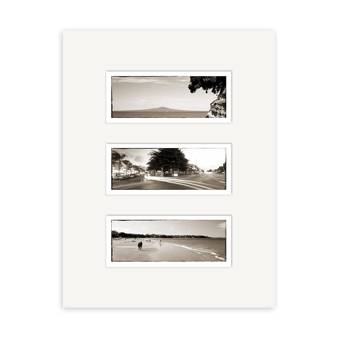 The Takapuna Triptych - RP088 features three vertically arranged black-and-white photos by Reuben Price on a white mat, showing a mountain, a New Zealand street, and a beach scene with people walking.