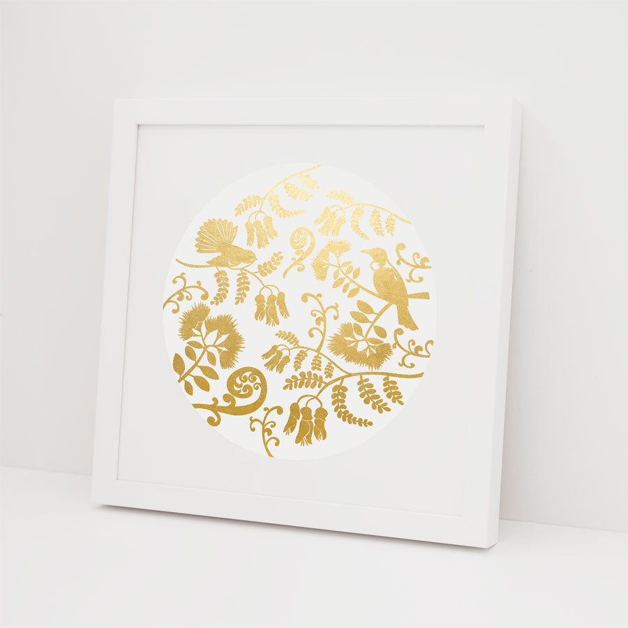 The NZ Design Foil Print is a framed artwork with a circular gold foil design of birds and botanicals on white—an elegant Kiwiana-inspired piece to enhance any space.