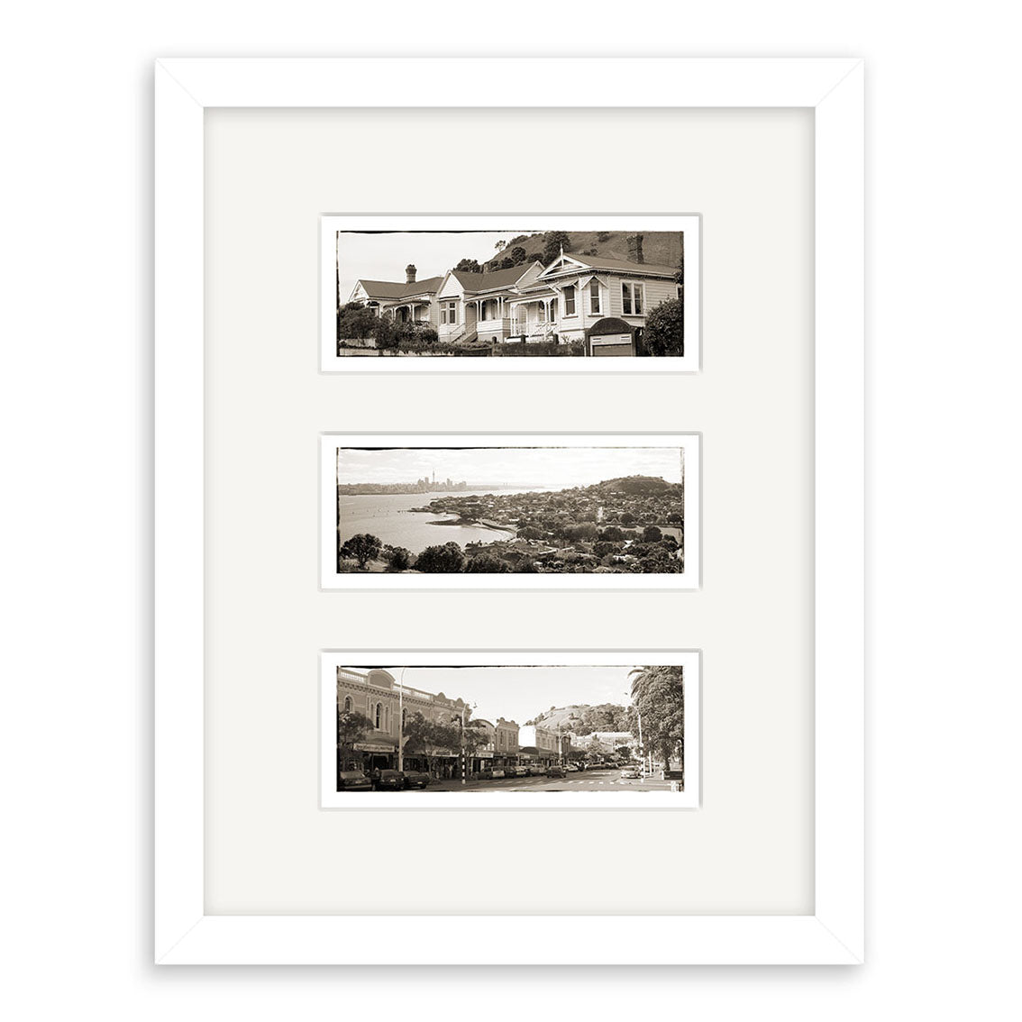 The Devonport Triptych – RP021 features three black-and-white prints in a white frame: houses at the top, a New Zealand coastal scene in the middle, and a street view with buildings and cars on archival matte paper.