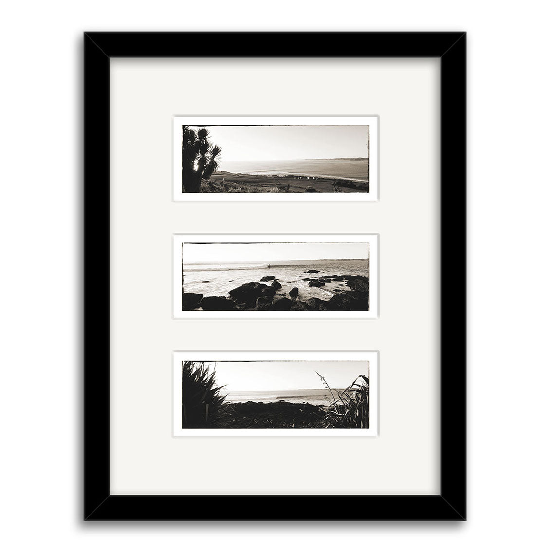 The Raglan Triptych - RP096 features a black frame with white mat, showcasing three vertically stacked black-and-white coastal prints on archival matte paper, each capturing water, rocks, and natural vegetation.