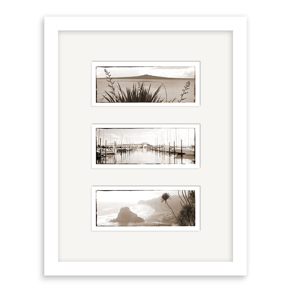 The Auckland Triptych - RP004 is a framed art print featuring three archival-quality sepia-toned landscape photographs of coastal scenes, each stacked vertically within a wide white mat and white frame.